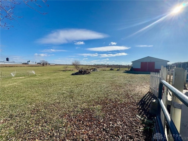 view of yard featuring an outdoor structure and a rural view