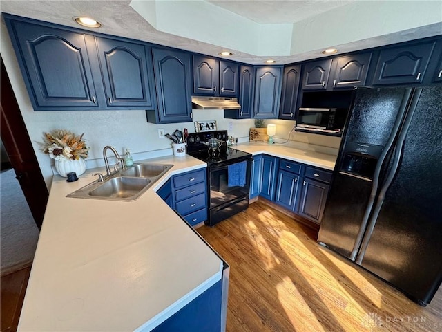 kitchen with blue cabinets, sink, light hardwood / wood-style flooring, and black appliances