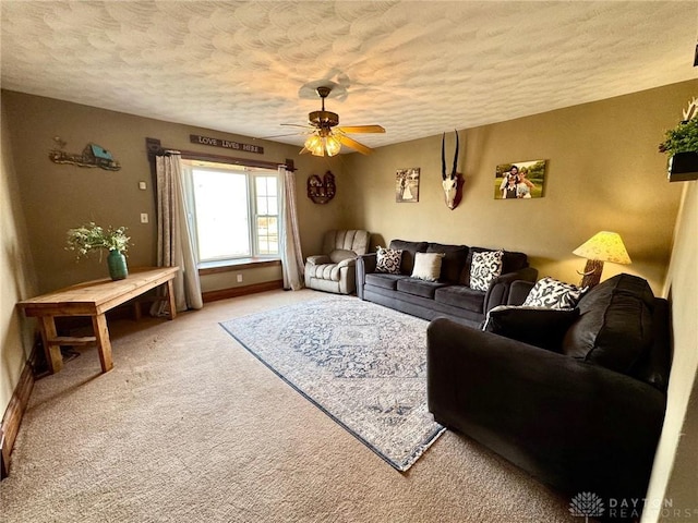 carpeted living room featuring ceiling fan and a textured ceiling