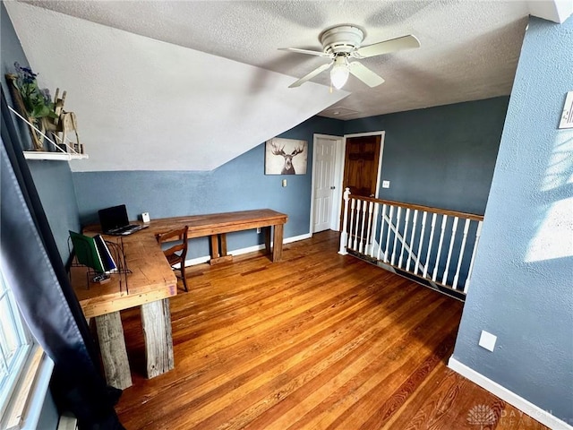 bonus room featuring wood-type flooring, vaulted ceiling, ceiling fan, and a textured ceiling