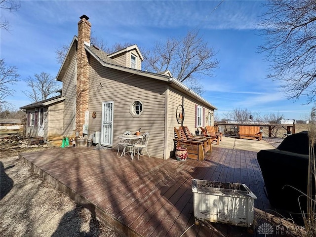 rear view of property featuring a wooden deck