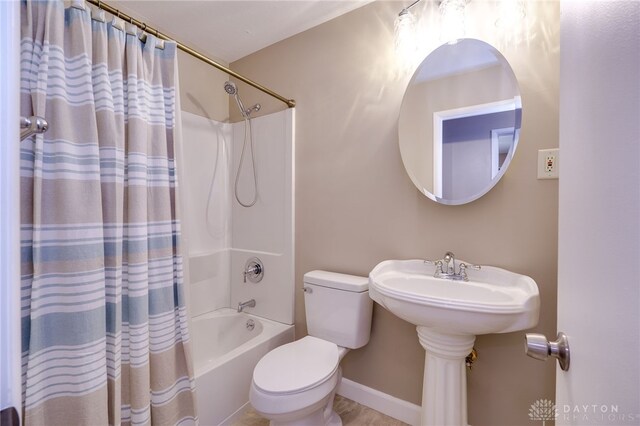 bathroom with shower / tub combo with curtain and toilet