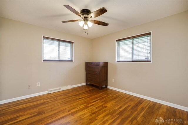 empty room with hardwood / wood-style flooring and ceiling fan