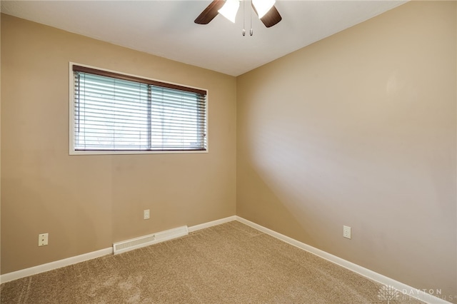 carpeted spare room with ceiling fan