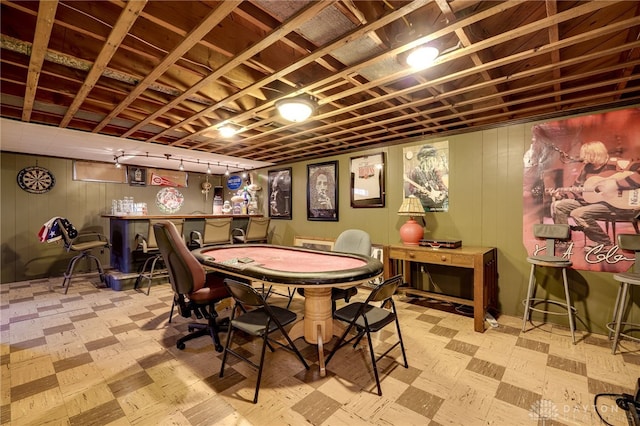 playroom with wooden walls and bar area