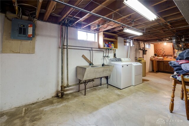 basement with washer and dryer, sink, and electric panel