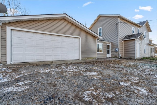 back of house featuring a garage