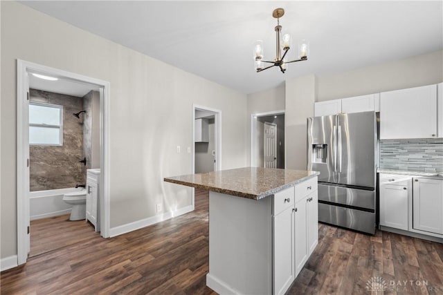 kitchen featuring pendant lighting, white cabinetry, stainless steel refrigerator with ice dispenser, and dark wood-type flooring