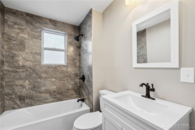 full bathroom with toilet, vanity, and tiled shower / bath