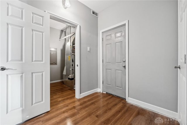 hallway with hardwood / wood-style flooring