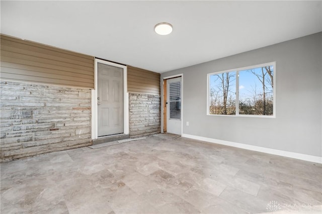 unfurnished bedroom with wood walls