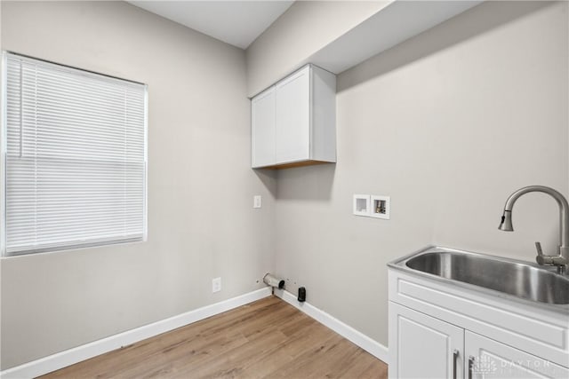 laundry room featuring cabinets, hookup for a gas dryer, sink, washer hookup, and light wood-type flooring