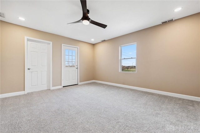 spare room with light carpet and ceiling fan