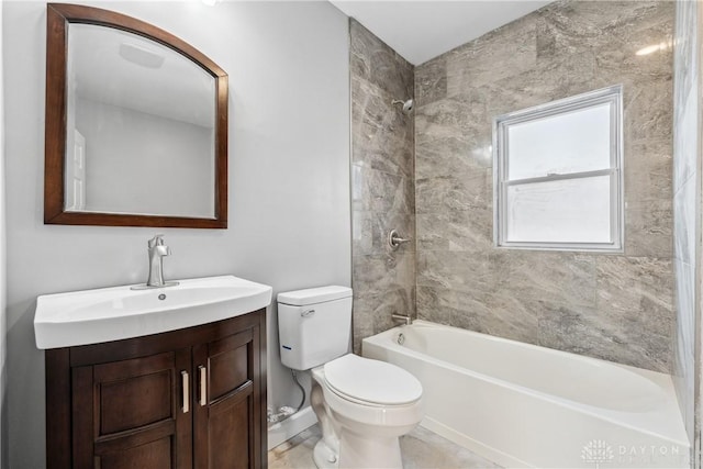 full bathroom with tiled shower / bath combo, toilet, and vanity