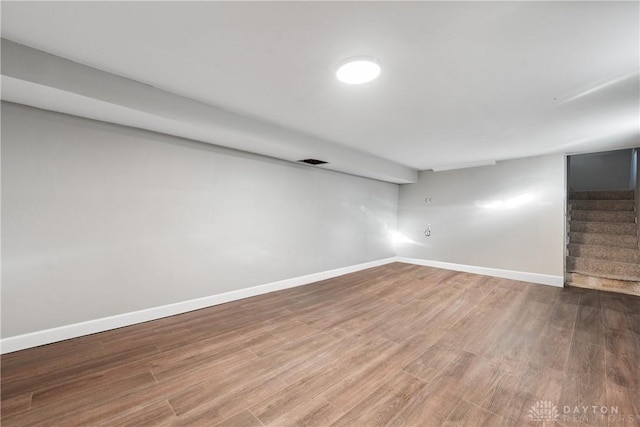 basement with hardwood / wood-style floors