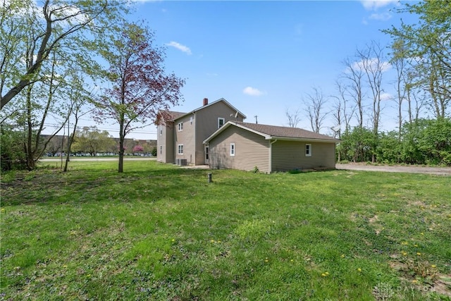 view of side of home featuring a lawn