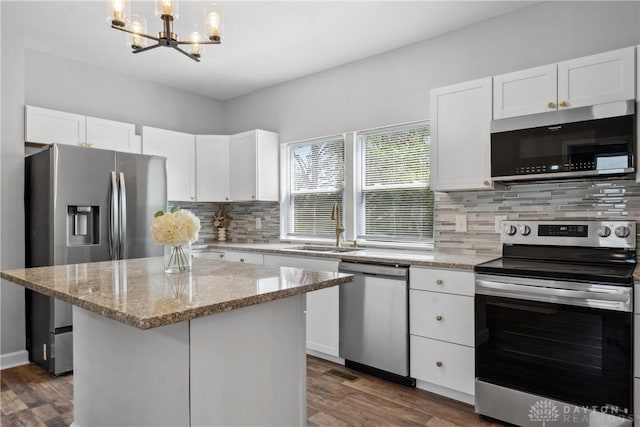 kitchen featuring white cabinetry, stainless steel appliances, dark wood-type flooring, and a sink