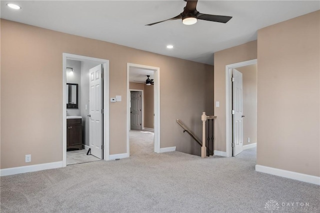unfurnished room featuring recessed lighting, a ceiling fan, baseboards, and light carpet