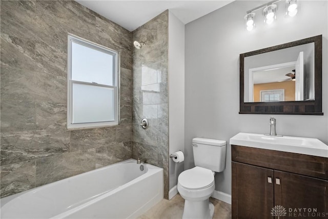 bathroom with baseboards, toilet, vanity, and plenty of natural light