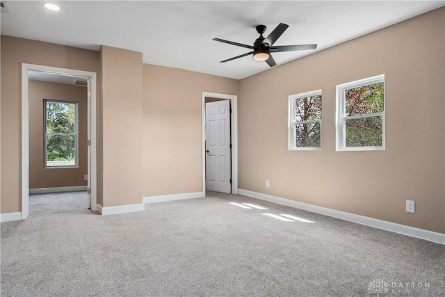 unfurnished bedroom featuring recessed lighting, baseboards, light colored carpet, and attic access