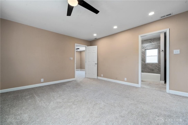 unfurnished bedroom featuring light carpet, baseboards, ensuite bath, visible vents, and recessed lighting
