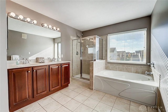 bathroom with tile patterned floors, vanity, and shower with separate bathtub