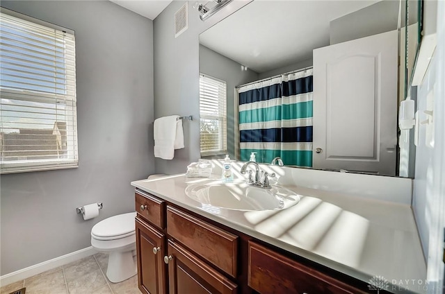 bathroom featuring toilet, vanity, and tile patterned floors