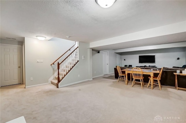 carpeted home office featuring a textured ceiling