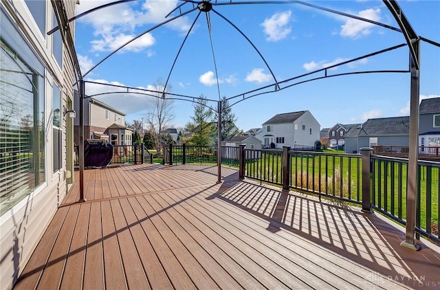 wooden deck featuring a yard