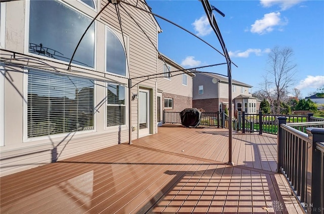 wooden deck featuring a grill