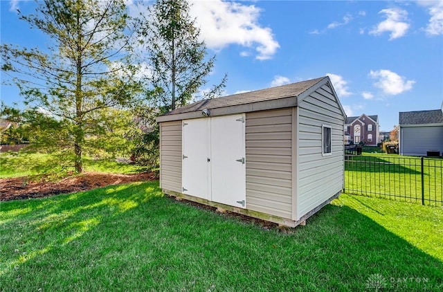 view of outbuilding featuring a lawn