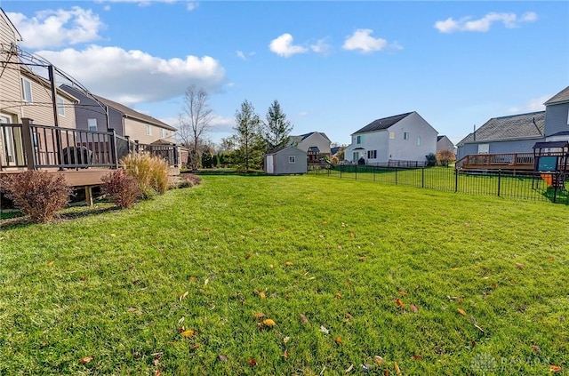 view of yard with a storage shed and a deck