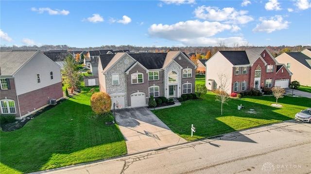 view of property featuring a garage and a front lawn