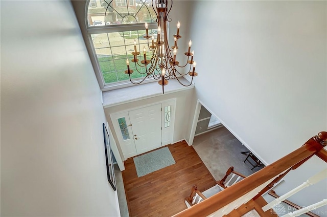 foyer featuring hardwood / wood-style flooring and an inviting chandelier