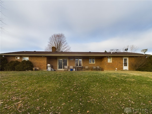 rear view of house with a lawn