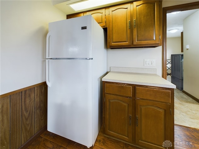 kitchen with white fridge and wood-type flooring