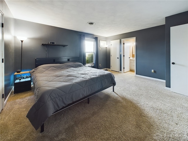 bedroom with carpet and ensuite bathroom