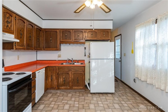 kitchen featuring white appliances, ceiling fan, and sink