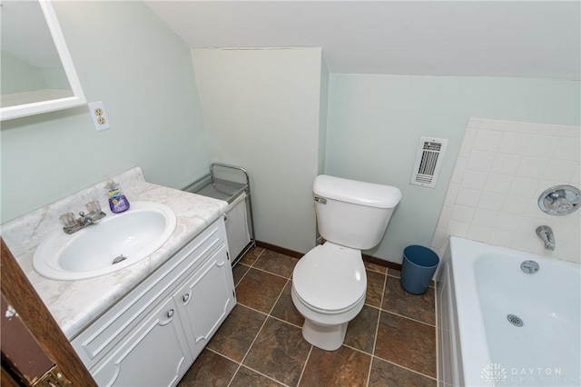 bathroom with vanity, toilet, lofted ceiling, and a tub to relax in