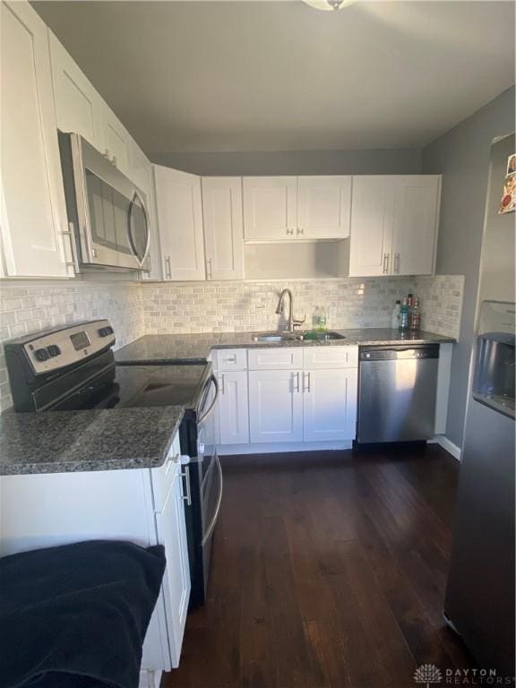 kitchen with stainless steel appliances, white cabinetry, dark hardwood / wood-style floors, and sink