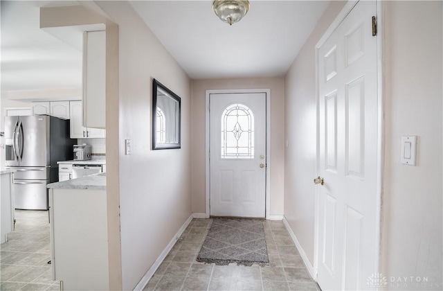 doorway with light tile patterned flooring