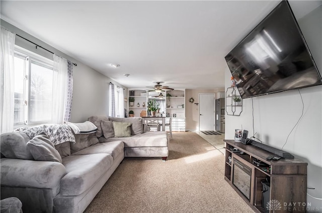 living room with carpet and ceiling fan