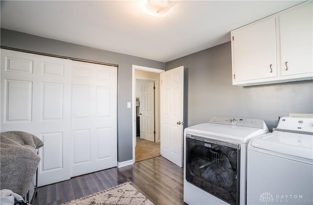 washroom featuring dark hardwood / wood-style flooring, cabinets, and independent washer and dryer