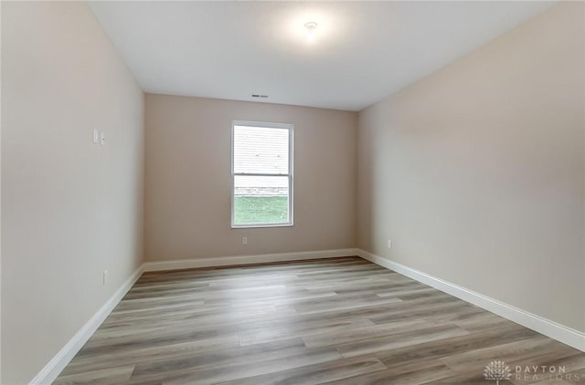 spare room with light hardwood / wood-style flooring