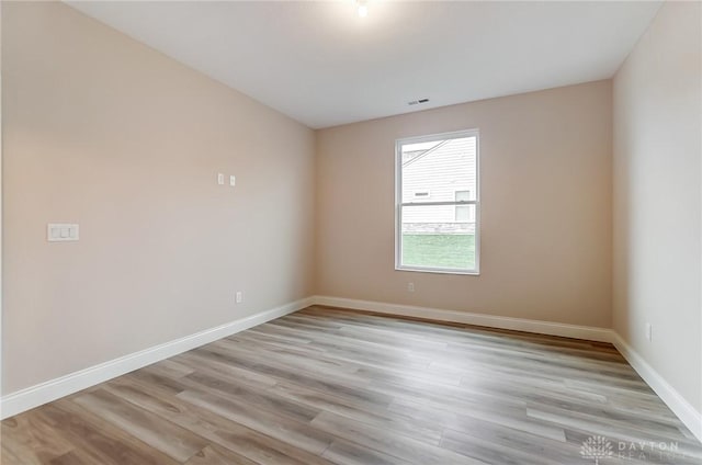 spare room featuring light hardwood / wood-style floors