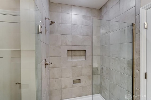 bathroom featuring a shower with door