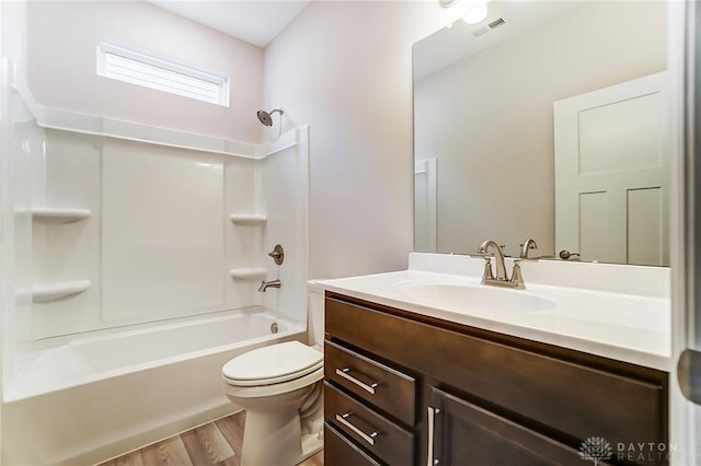 full bathroom with hardwood / wood-style floors, vanity, toilet, and shower / washtub combination