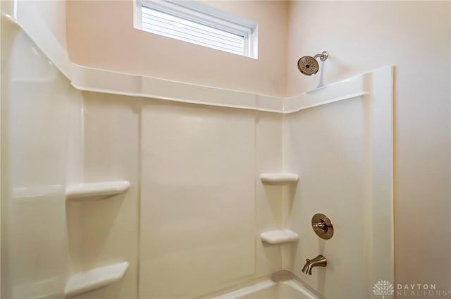 bathroom with shower / washtub combination