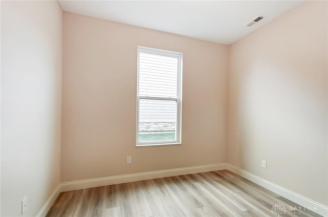 empty room with light hardwood / wood-style flooring and a healthy amount of sunlight