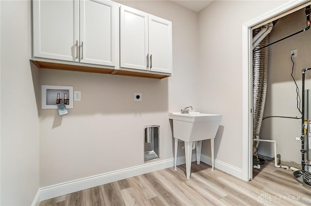 washroom featuring cabinets, hookup for a washing machine, light hardwood / wood-style floors, and hookup for an electric dryer